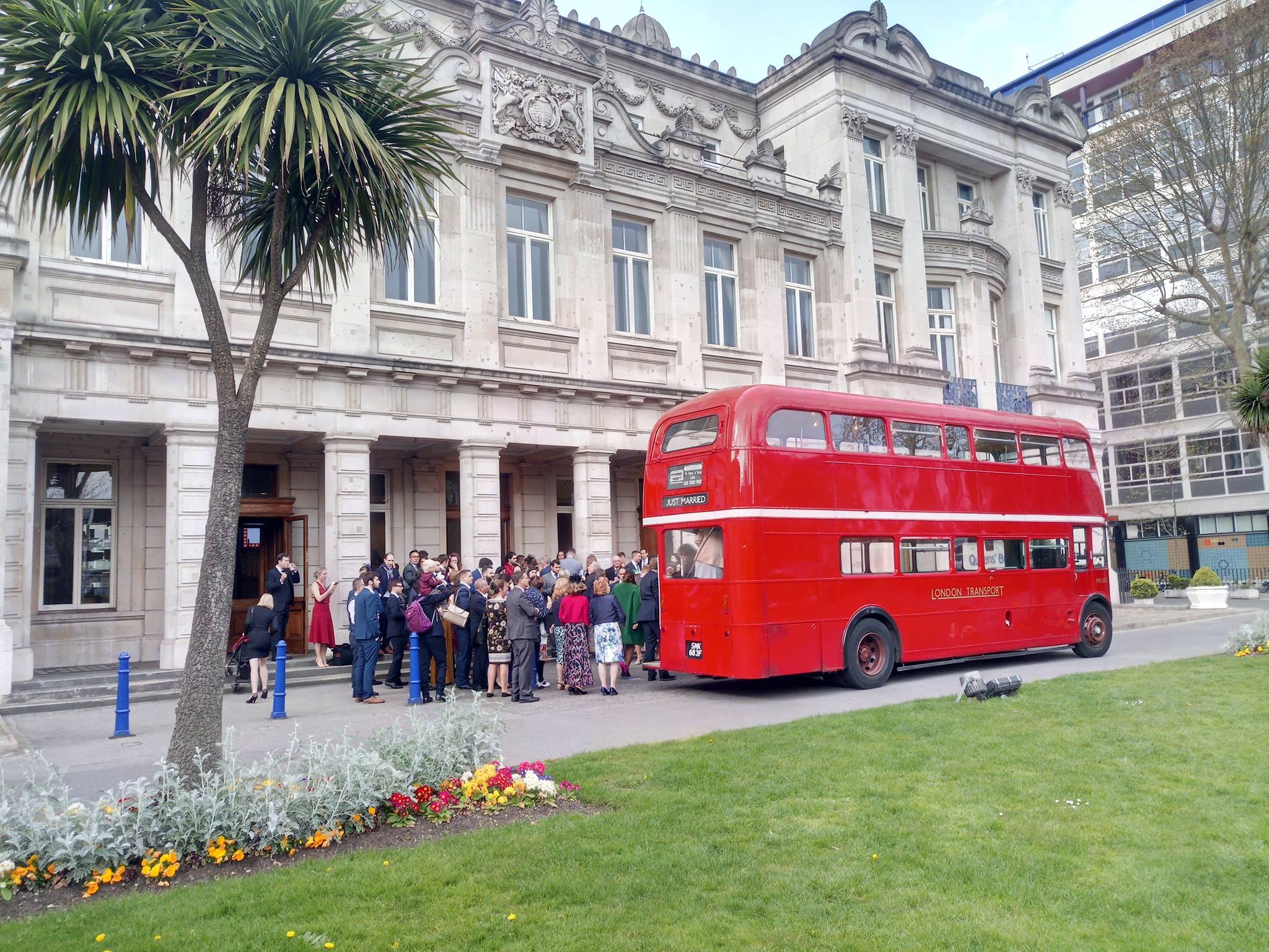 Routemaster bus outside of a wedding venue ready to receive the married couple