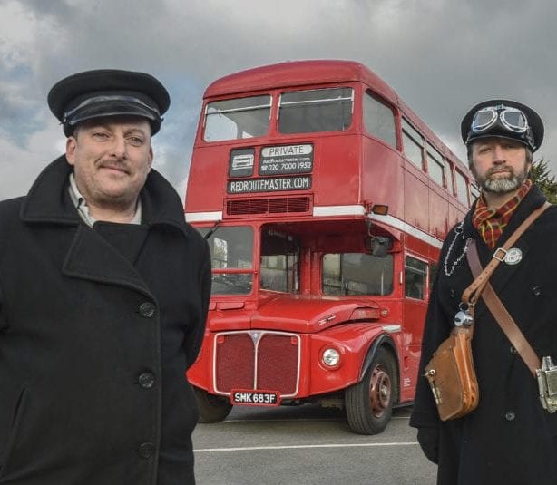 Conductor and driver pictured infront of a Redroutemaster.com bus