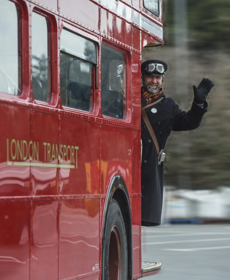 Conductor waving from the back of a Routemaster bus
